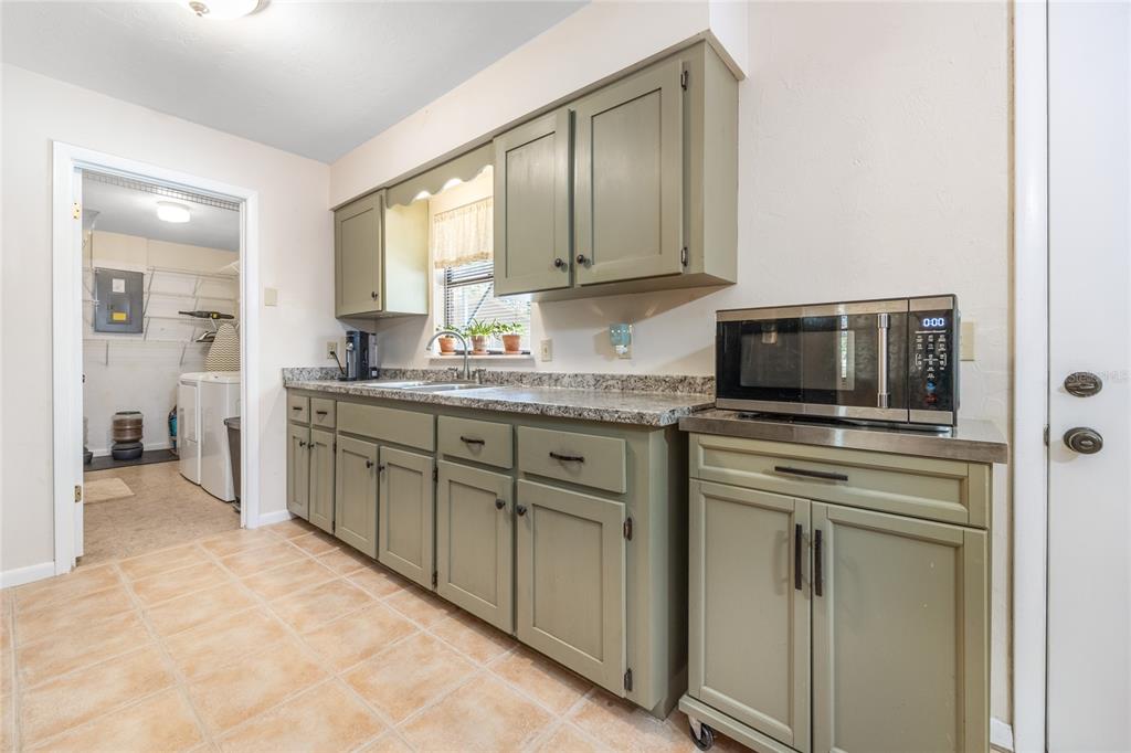 545 Southwest 257 Terrace Newberry, FL 32669 - Photo 11 of 46 a kitchen with a sink and cabinets