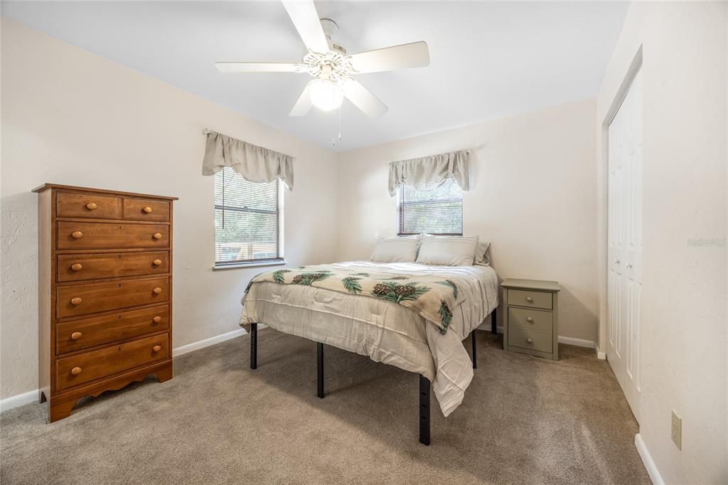 545 Southwest 257 Terrace Newberry, FL 32669 - Photo 15 of 46 a bedroom with a bed and a dresser