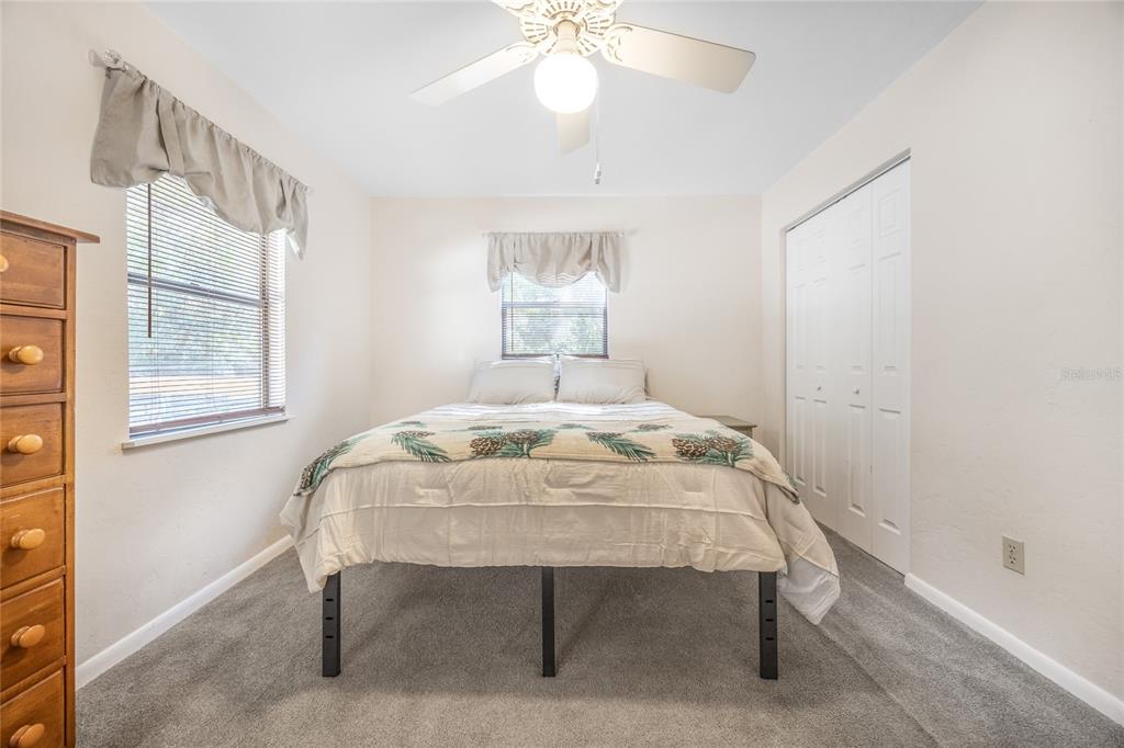 545 Southwest 257 Terrace Newberry, FL 32669 - Photo 18 of 46 a bedroom with a bed and a table