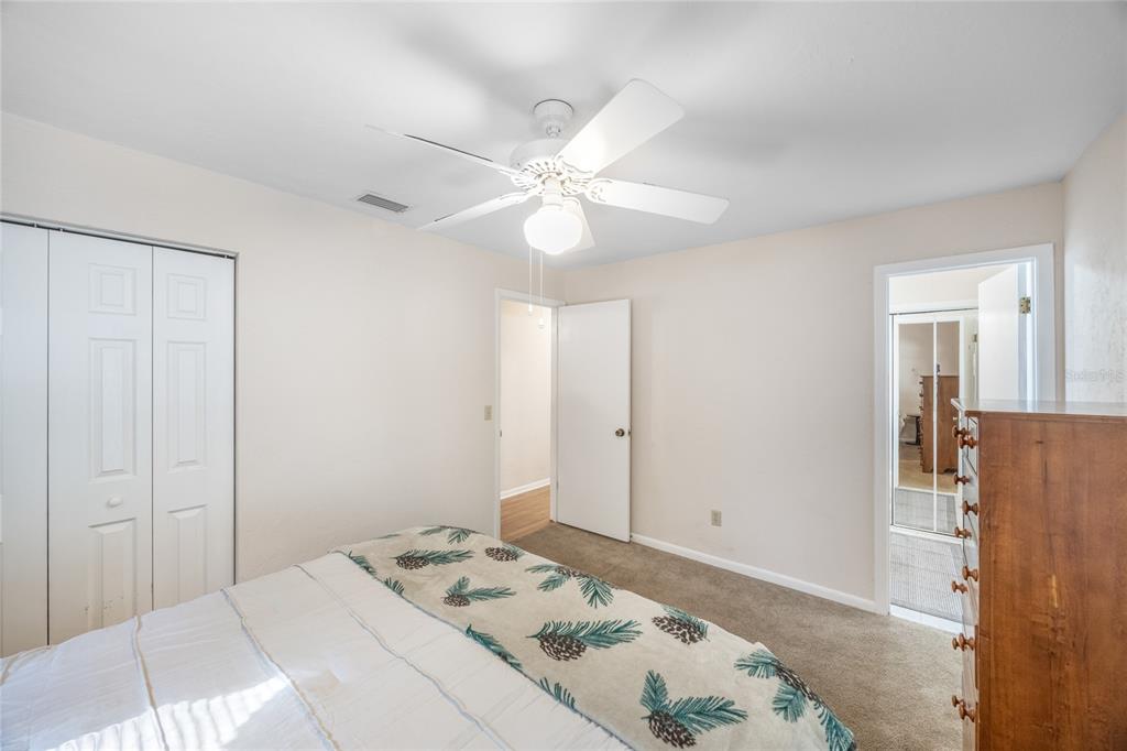 545 Southwest 257 Terrace Newberry, FL 32669 - Photo 19 of 46 a bedroom with a bed and a chandelier