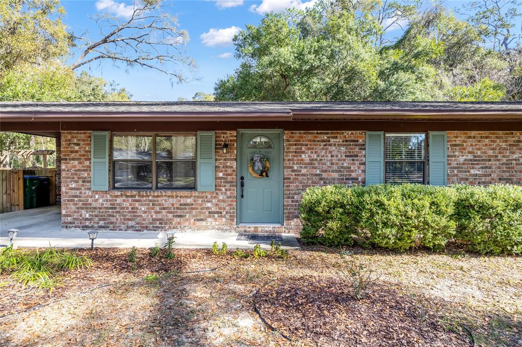 545 Southwest 257 Terrace Newberry, FL 32669 - Photo 2 of 46 a front view of a house with garden