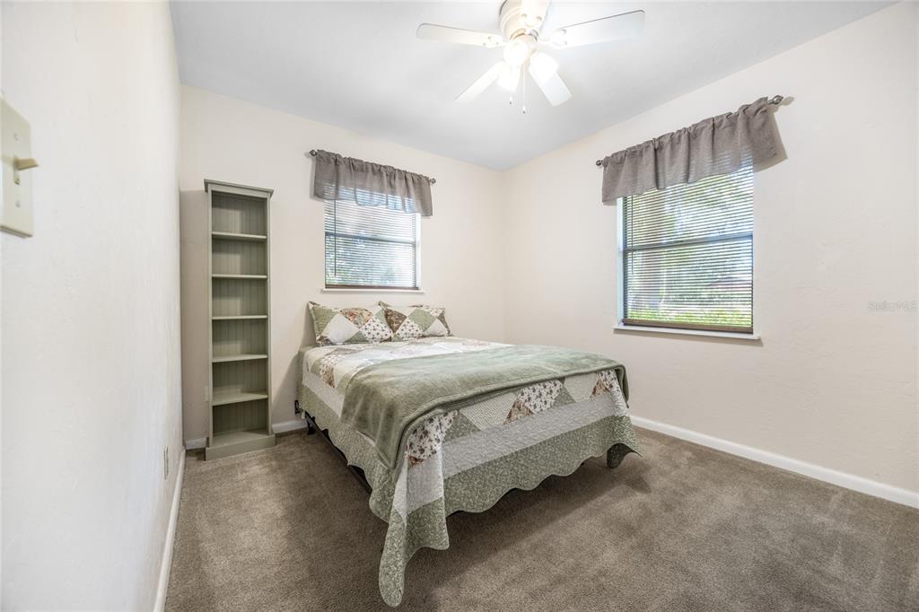 545 Southwest 257 Terrace Newberry, FL 32669 - Photo 21 of 46 a bedroom with a bed and a chandelier