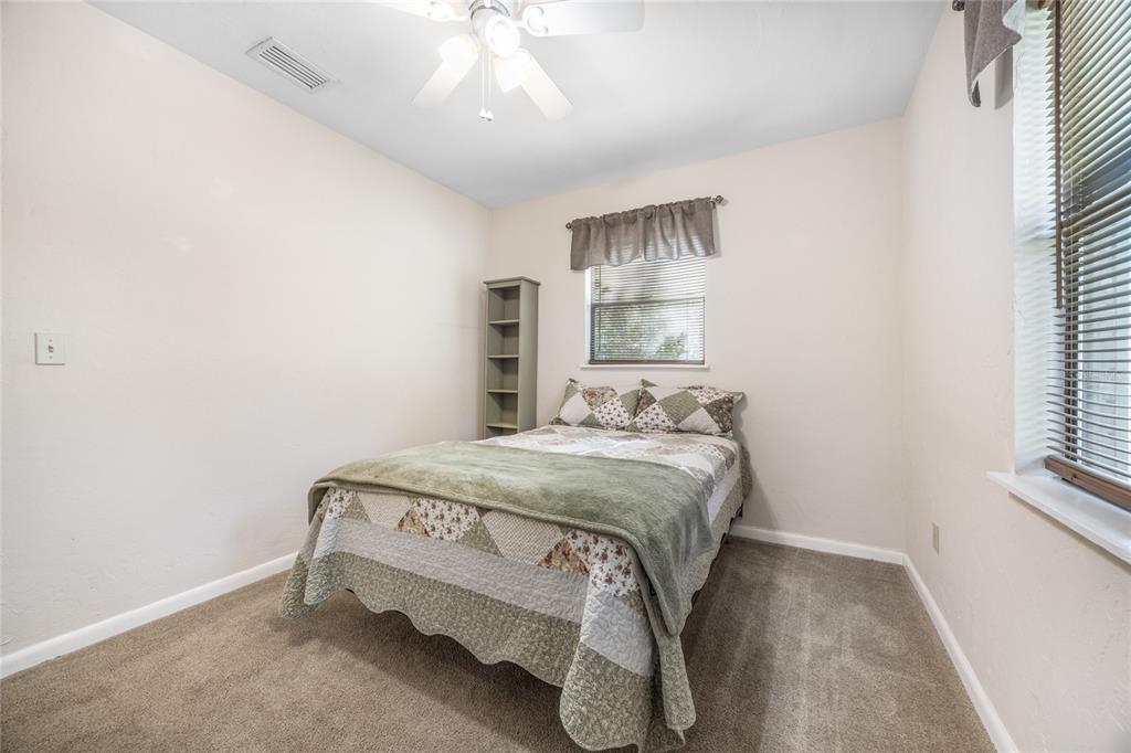 545 Southwest 257 Terrace Newberry, FL 32669 - Photo 23 of 46 a bedroom with a bed and a chandelier
