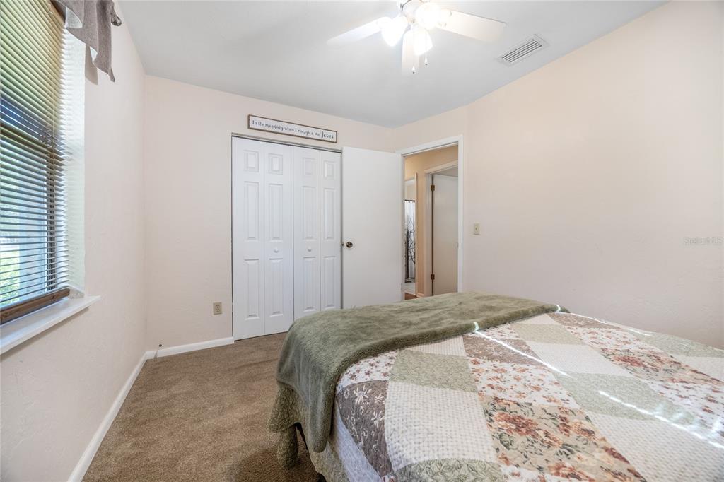 545 Southwest 257 Terrace Newberry, FL 32669 - Photo 24 of 46 a bedroom with a bed and a chandelier