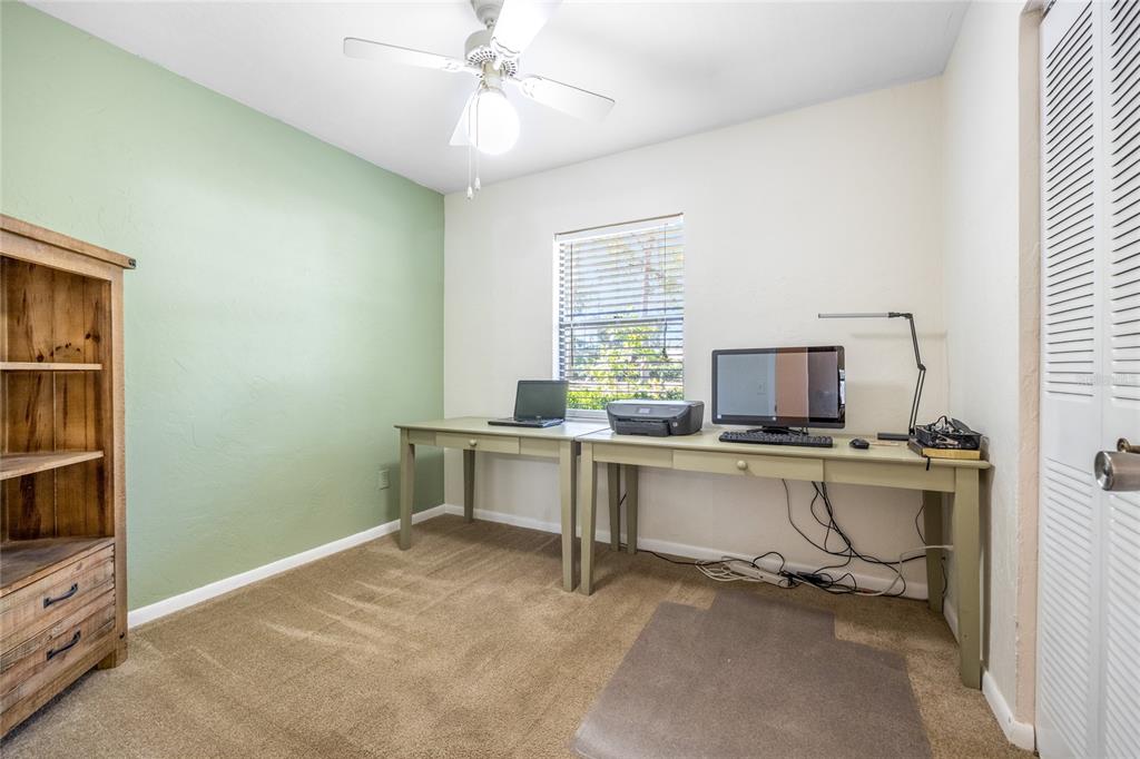 545 Southwest 257 Terrace Newberry, FL 32669 - Photo 27 of 46 a view of workspace with windows cabinet and flat screen tv