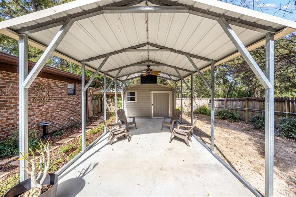 545 Southwest 257 Terrace Newberry, FL 32669 - Photo 32 of 46 a view of a patio with table and chairs under an umbrella