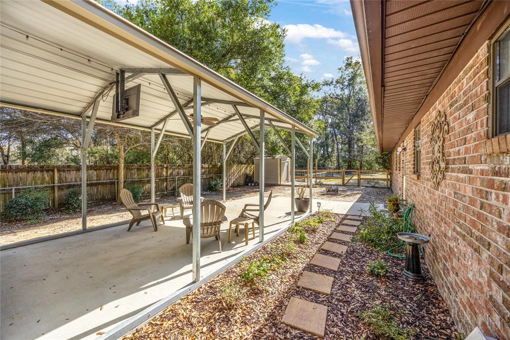 545 Southwest 257 Terrace Newberry, FL 32669 - Photo 33 of 46 a view of a chair and tables in the balcony