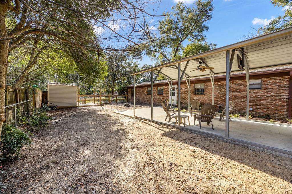 545 Southwest 257 Terrace Newberry, FL 32669 - Photo 35 of 46 a view of a house with backyard and sitting area