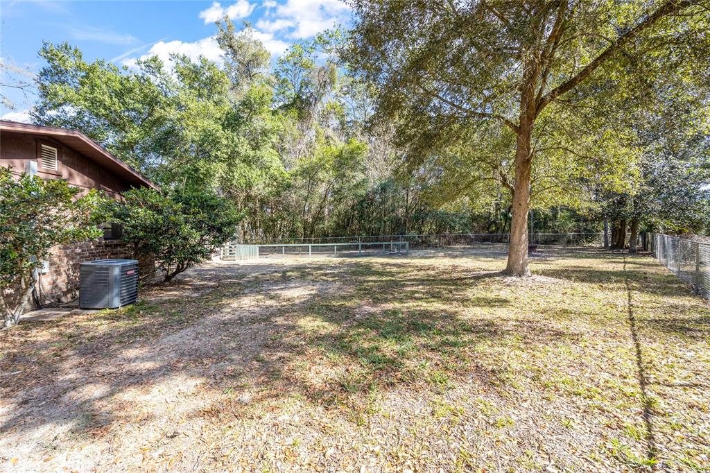 545 Southwest 257 Terrace Newberry, FL 32669 - Photo 39 of 46 a backyard of a house with table and chairs