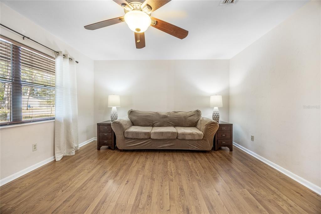545 Southwest 257 Terrace Newberry, FL 32669 - Photo 4 of 46 a living room with furniture and a wooden floor
