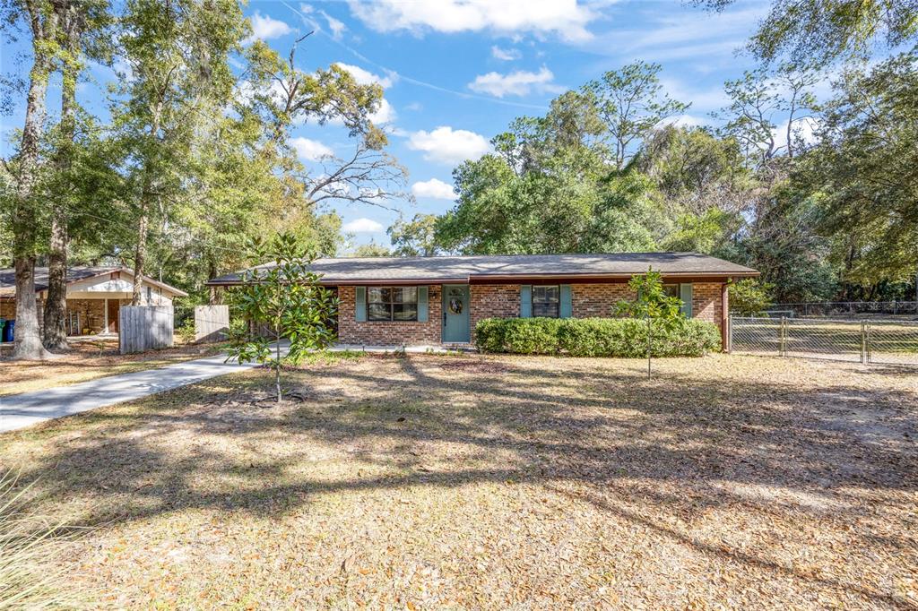 545 Southwest 257 Terrace Newberry, FL 32669 - Photo 42 of 46 front view of a house with a yard