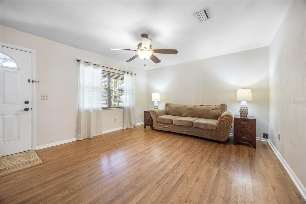 545 Southwest 257 Terrace Newberry, FL 32669 - Photo 6 of 46 a living room with furniture and wooden floor