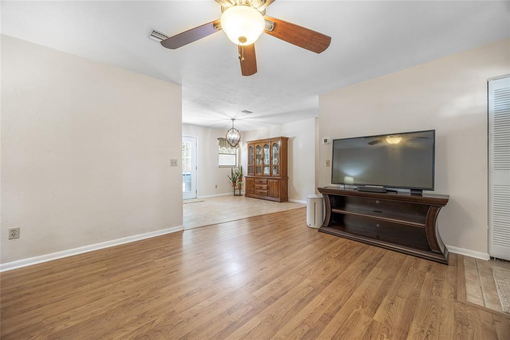 545 Southwest 257 Terrace Newberry, FL 32669 - Photo 7 of 46 wooden floor in an empty room with a window
