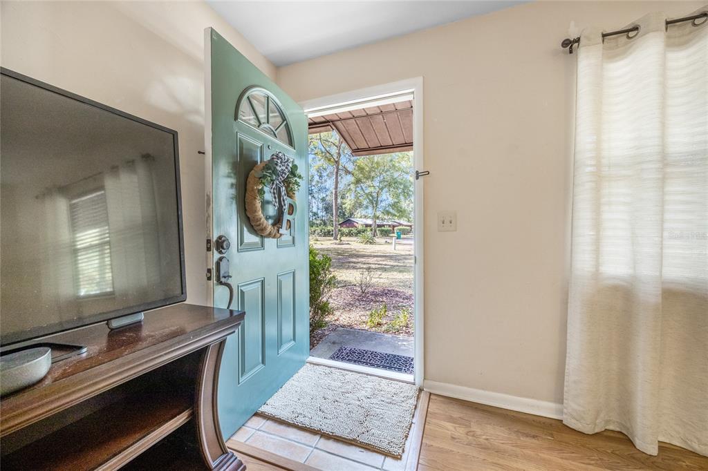 545 Southwest 257 Terrace Newberry, FL 32669 - Photo 8 of 46 a view of a hallway and a livingroom with furniture