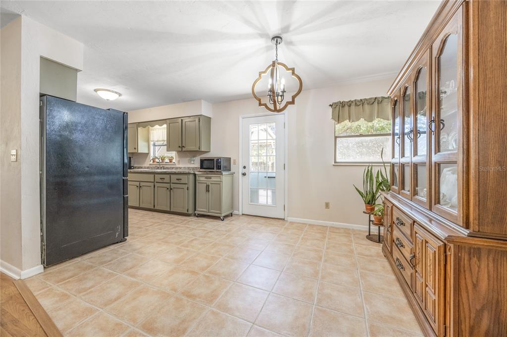 545 Southwest 257 Terrace Newberry, FL 32669 - Photo 10 of 46 a view of a kitchen with a sink dishwasher and a large window
