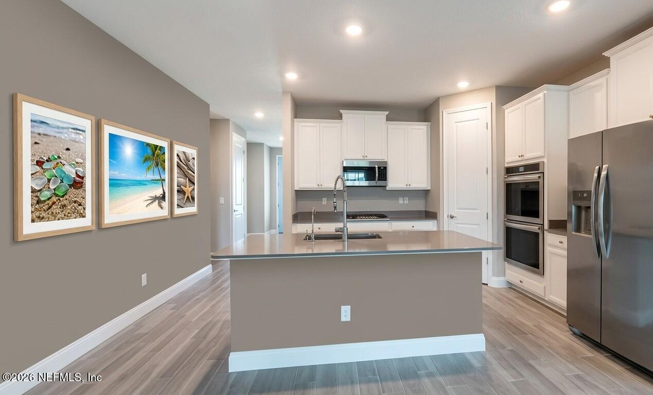 378 Varner Way St. Augustine, FL 32092 - Photo 3 of 8 a kitchen with stainless steel appliances a refrigerator and a stove top oven