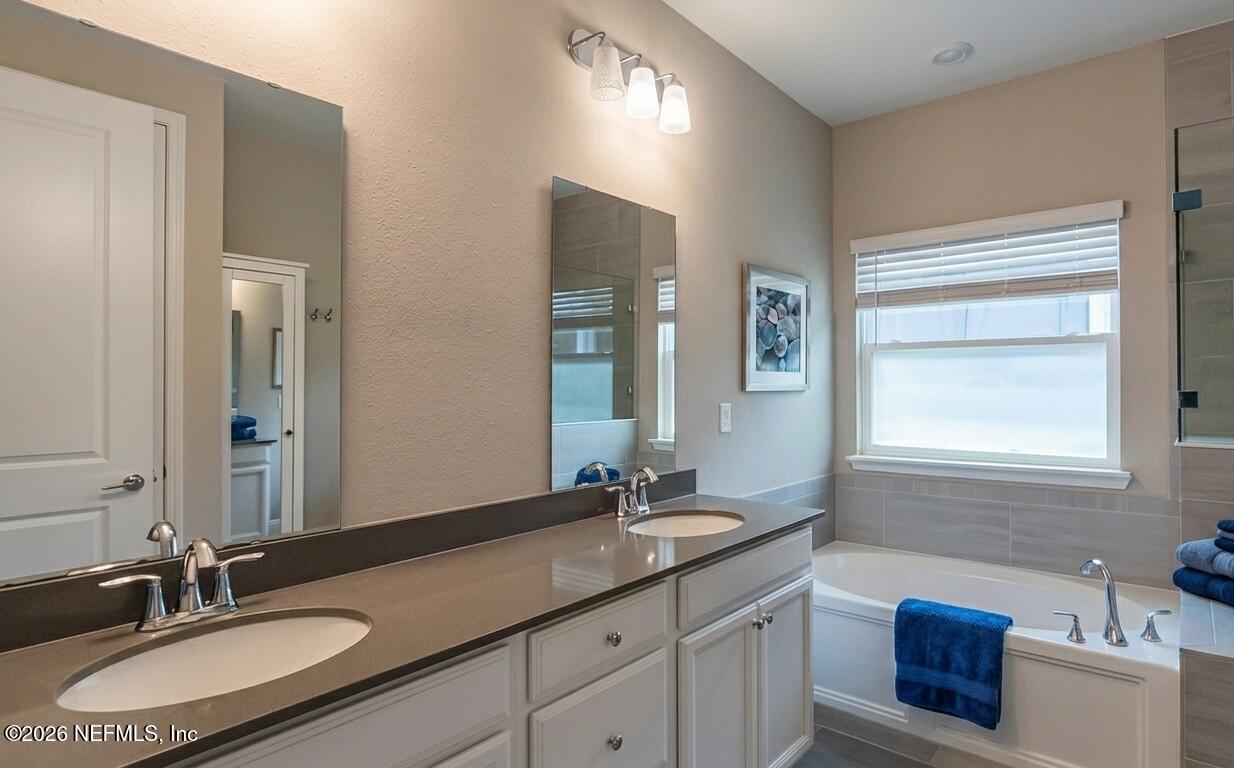 378 Varner Way St. Augustine, FL 32092 - Photo 6 of 8 a bathroom with a granite countertop sink and a mirror