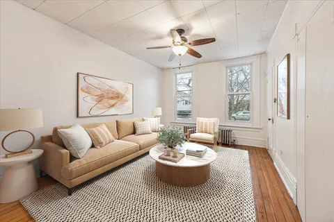 a living room with furniture a chandelier and a window