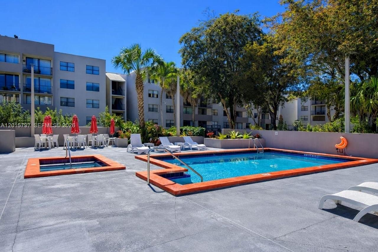 8002 Southwest 149th Avenue, Unit B310 Miami, FL 33193 - Photo 15 of 16 a view of pool with outdoor seating and trees
