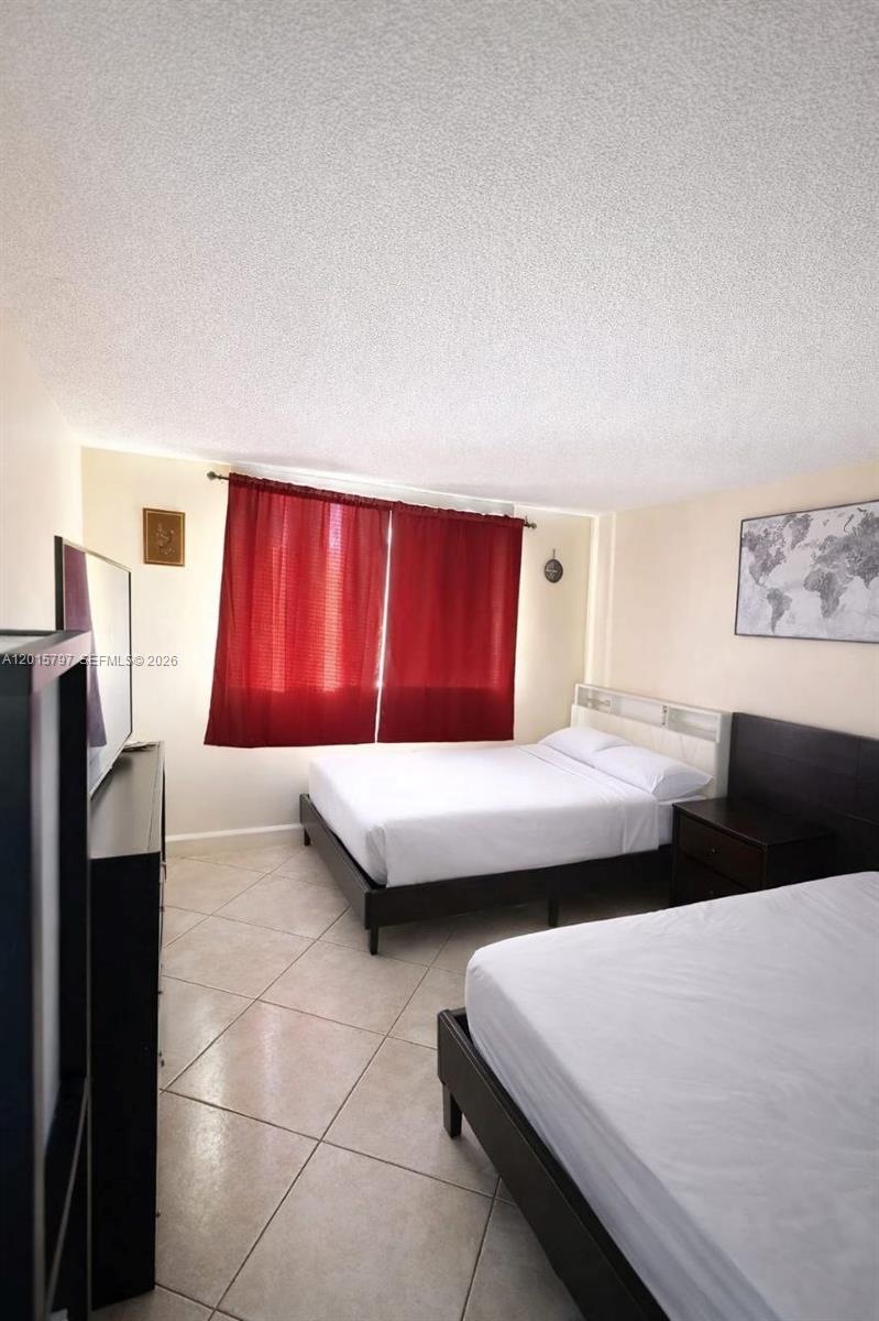 8002 Southwest 149th Avenue, Unit B310 Miami, FL 33193 - Photo 2 of 16 a bedroom with a bed and window