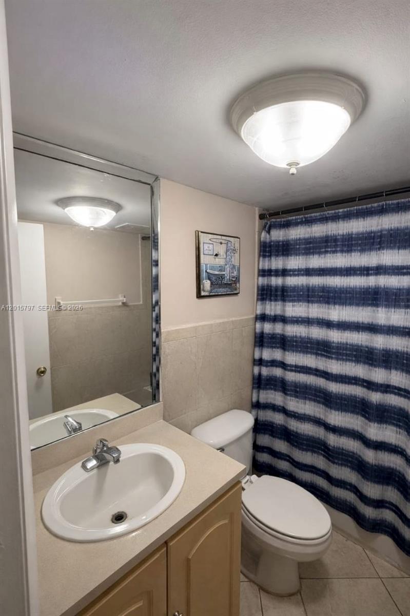 8002 Southwest 149th Avenue, Unit B310 Miami, FL 33193 - Photo 3 of 16 a bathroom with a sink toilet and mirror