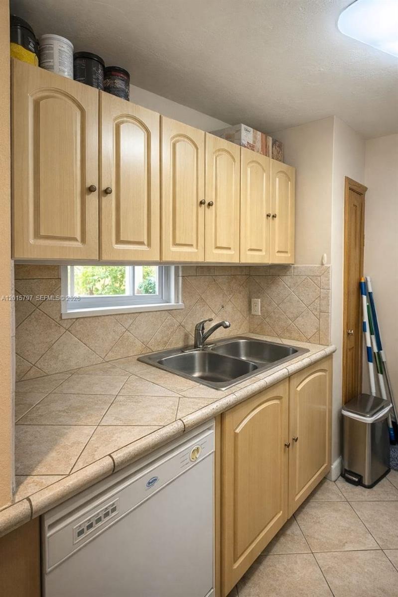 8002 Southwest 149th Avenue, Unit B310 Miami, FL 33193 - Photo 5 of 16 a kitchen with stainless steel appliances granite countertop a sink stove and cabinets