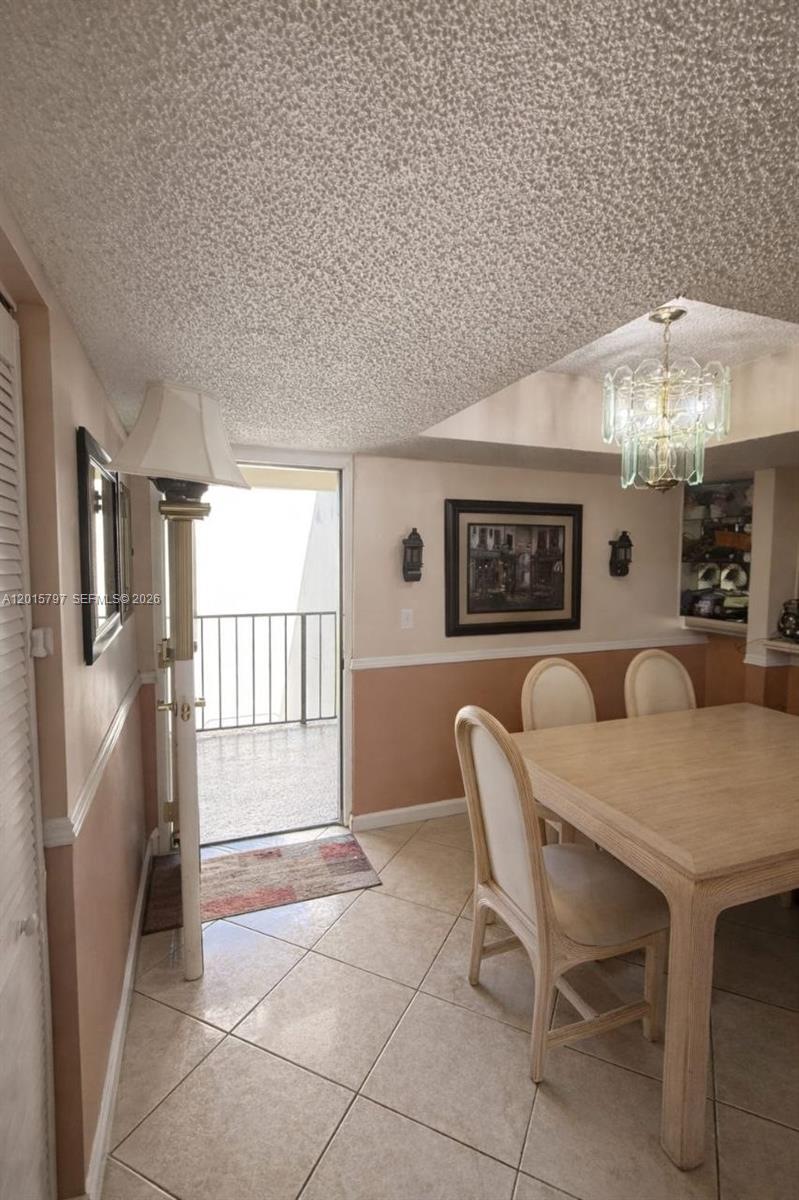 8002 Southwest 149th Avenue, Unit B310 Miami, FL 33193 - Photo 6 of 16 a dining room with furniture and window