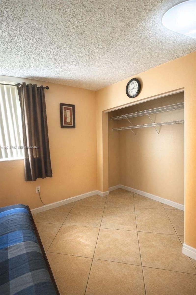 8002 Southwest 149th Avenue, Unit B310 Miami, FL 33193 - Photo 7 of 16 an empty room with windows