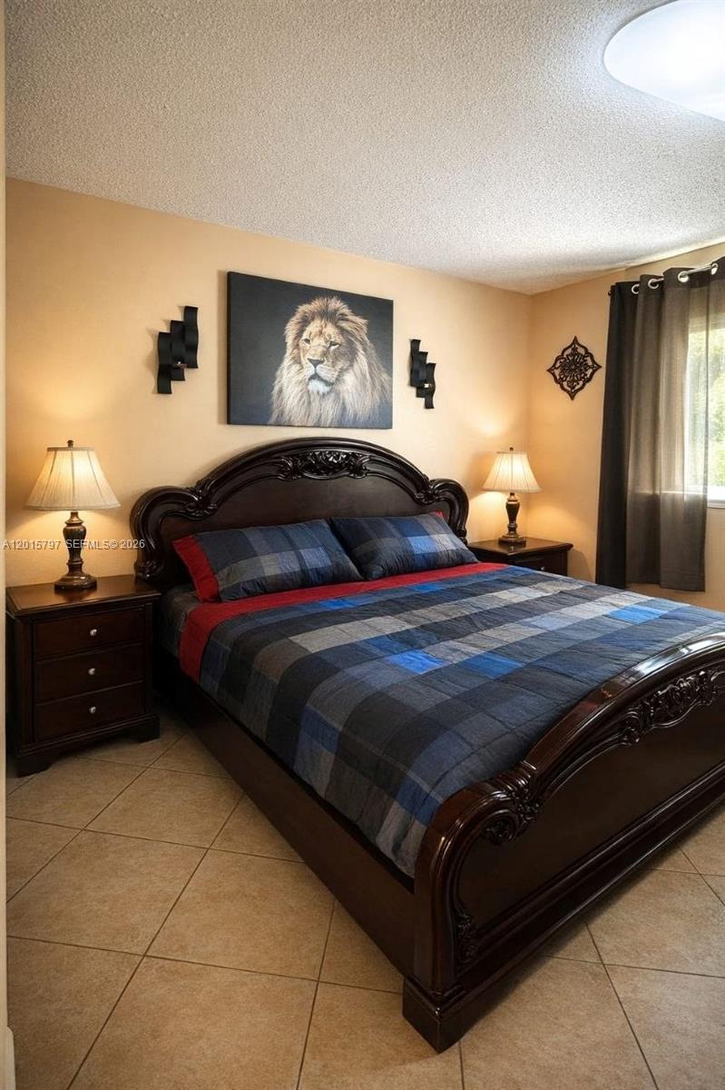 8002 Southwest 149th Avenue, Unit B310 Miami, FL 33193 - Photo 8 of 16 a bedroom with a bed and a closet