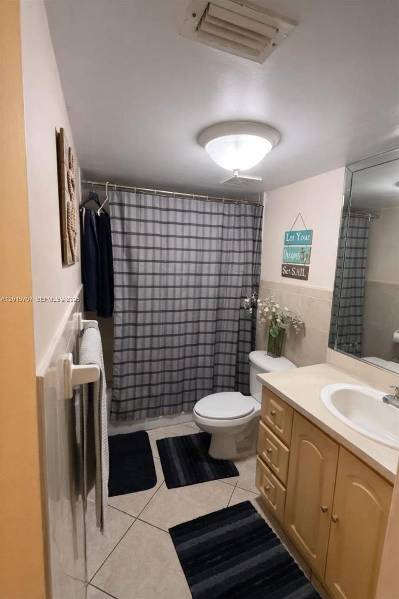8002 Southwest 149th Avenue, Unit B310 Miami, FL 33193 - Photo 10 of 16 a bathroom with a sink toilet and shower