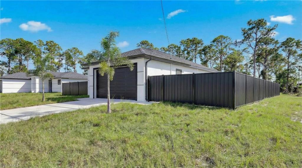 3419 8th Street Southwest Lehigh Acres, FL 33976 - Photo 2 of 29 a house with tree in front of it