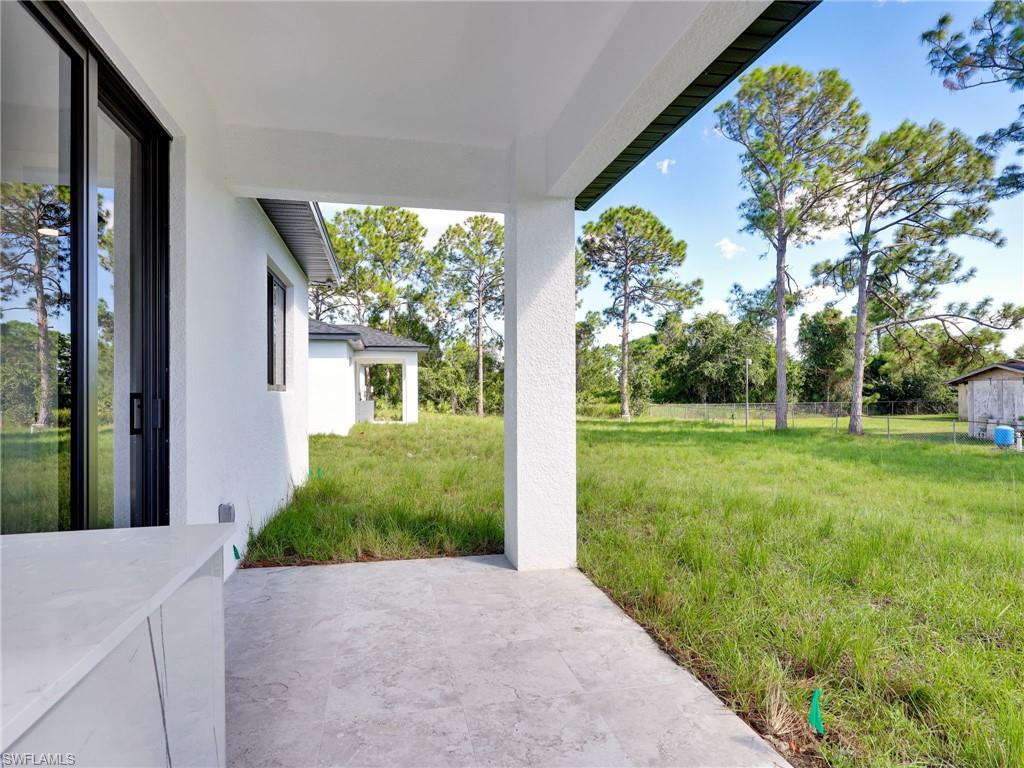 3419 8th Street Southwest Lehigh Acres, FL 33976 - Photo 26 of 29 a front view of a house with garden