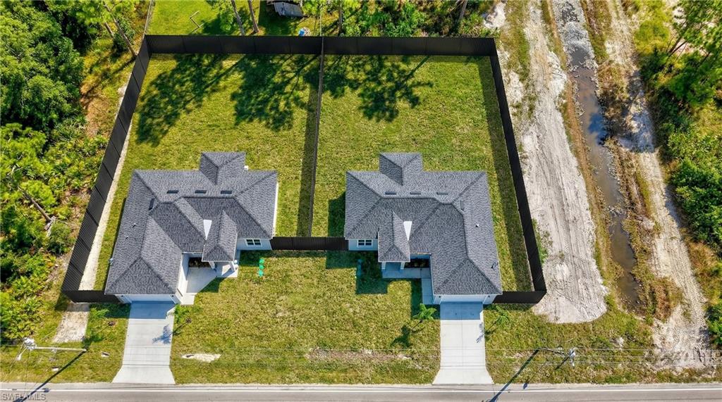 3419 8th Street Southwest Lehigh Acres, FL 33976 - Photo 27 of 29 front view of a house with a yard