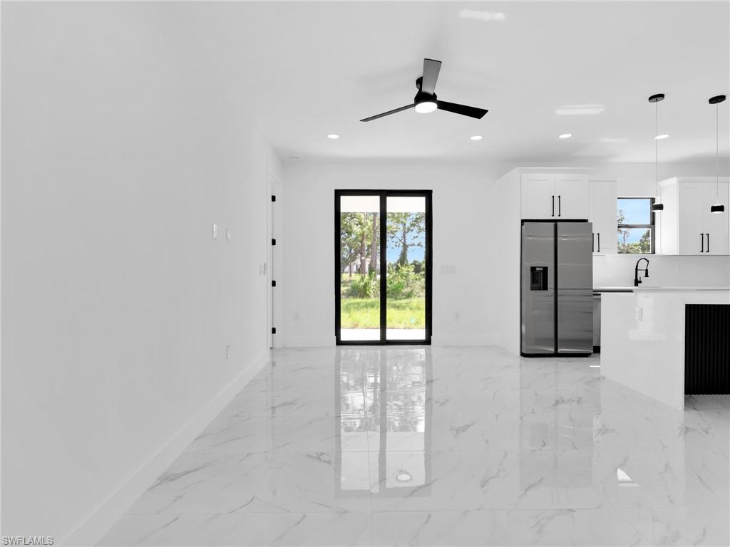 3419 8th Street Southwest Lehigh Acres, FL 33976 - Photo 4 of 29 a view of a kitchen with refrigerator and windows