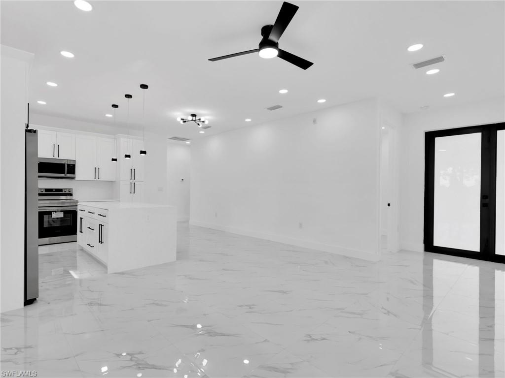 3419 8th Street Southwest Lehigh Acres, FL 33976 - Photo 8 of 29 a view of a kitchen with electric appliances