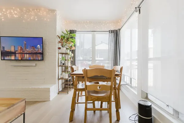 a view of a dining room with furniture and a potted plant