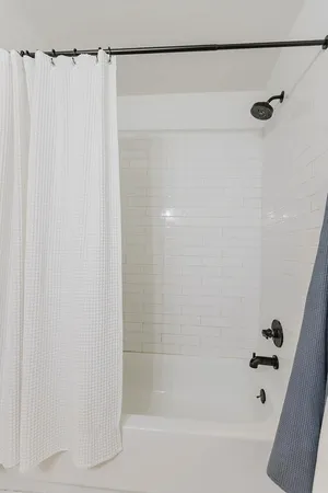 a bathroom with a shower and a bath tub