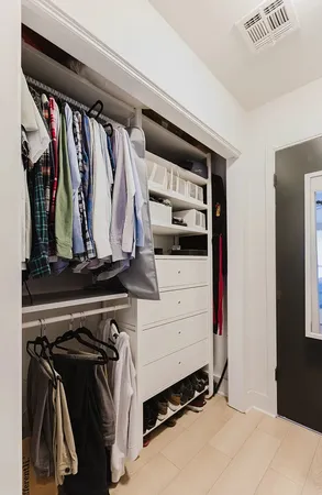 a view of walk in closet with clothes and shoes