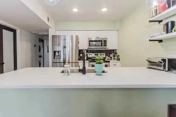 a bathroom with a sink a counter space and a mirror