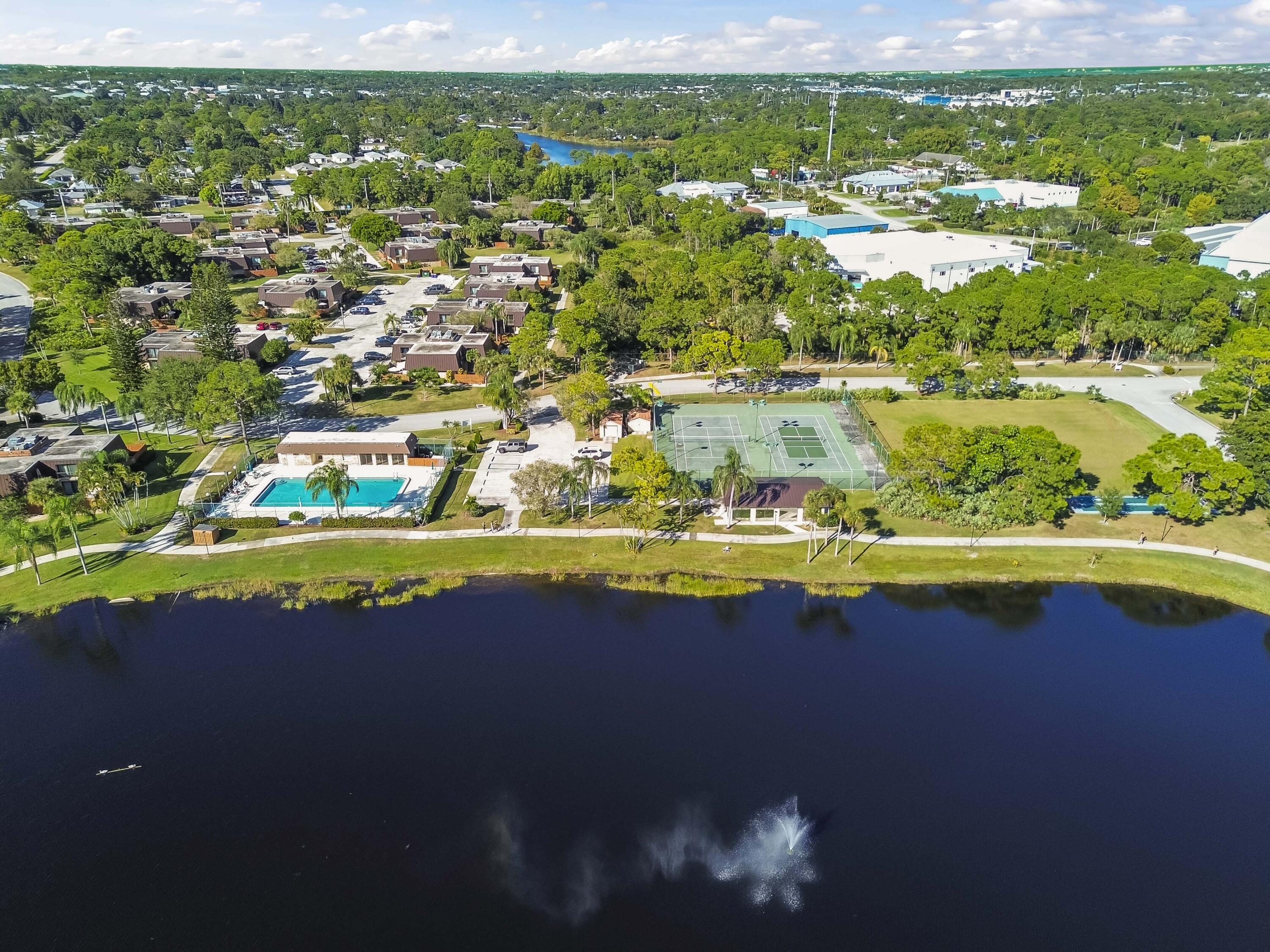 5708 Southeast Windsong Lane Stuart, FL 34997 - Photo 33 of 41 a view of a lake with a city