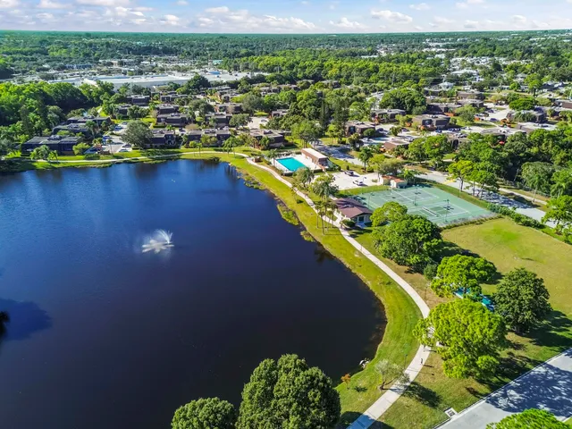 an aerial view of residential houses with outdoor space and swimming pool
