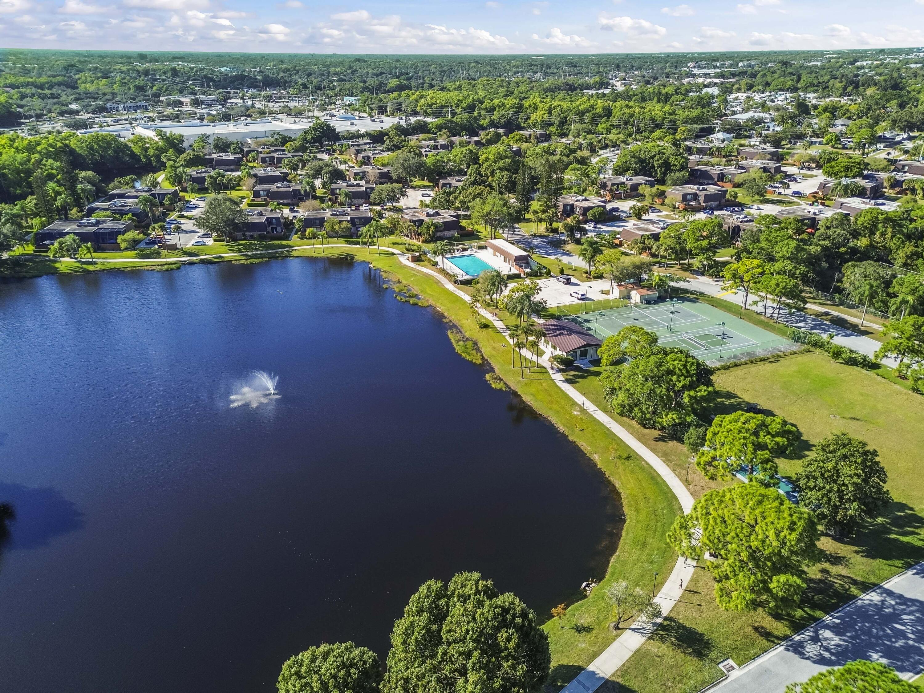 5708 Southeast Windsong Lane Stuart, FL 34997 - Photo 34 of 41 an aerial view of residential houses with outdoor space and swimming pool
