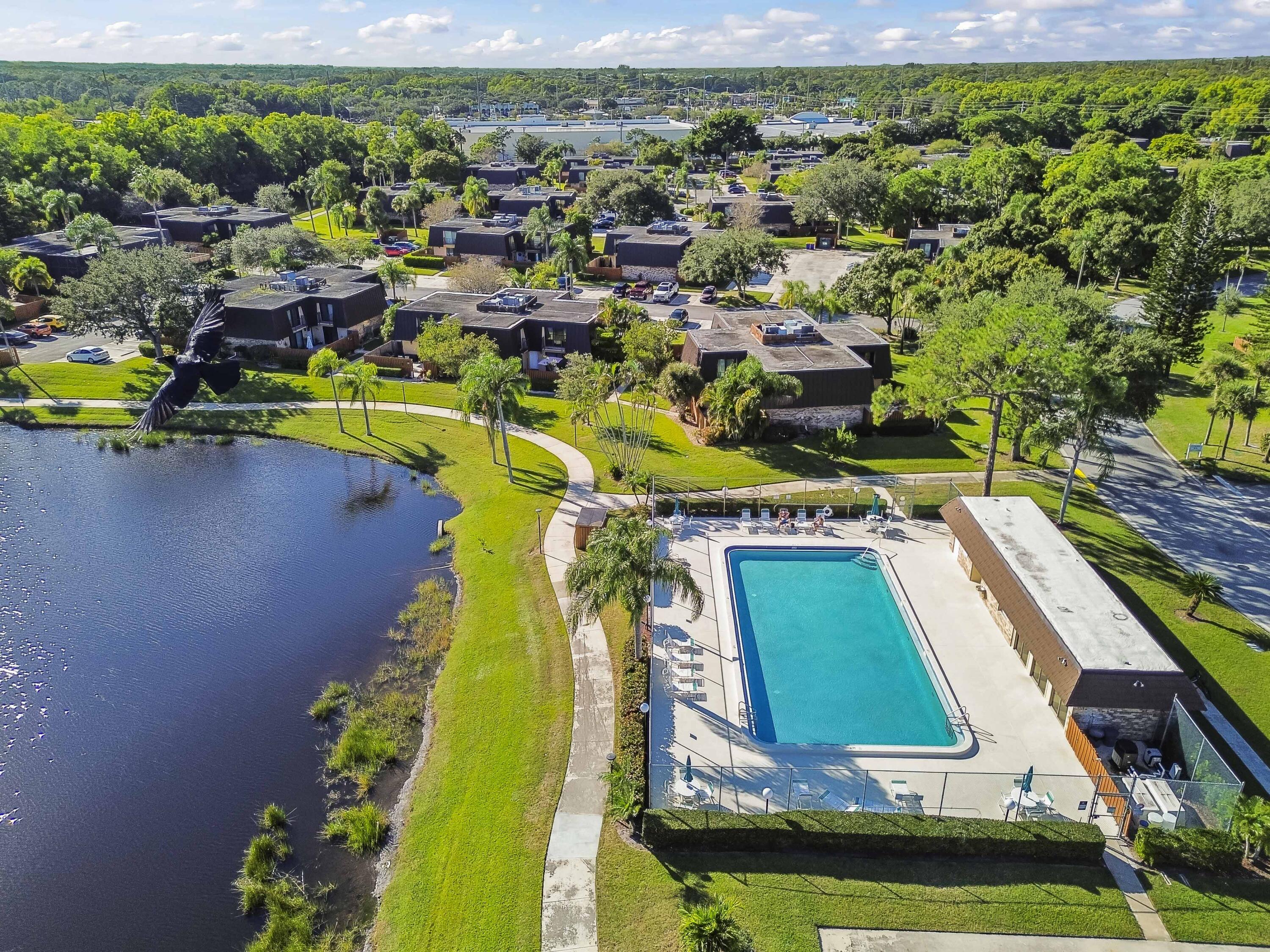 5708 Southeast Windsong Lane Stuart, FL 34997 - Photo 37 of 41 a view of a swimming pool with outdoor seating and yard