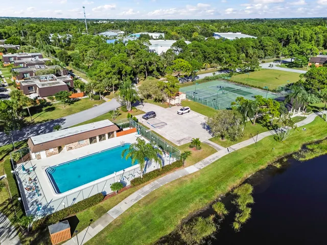 an aerial view of residential houses with outdoor space and street view