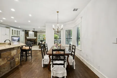 a dining room with furniture window and wooden floor