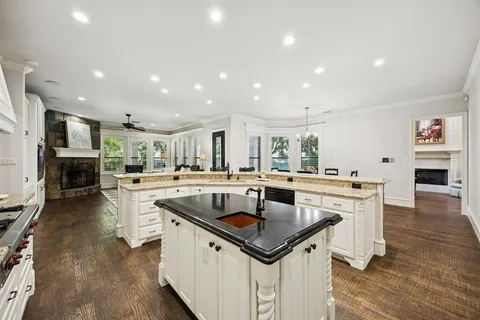 a kitchen with granite countertop a sink and stove