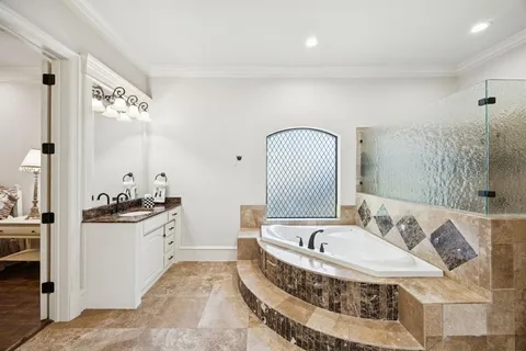 a bathroom with a tub sink and mirror