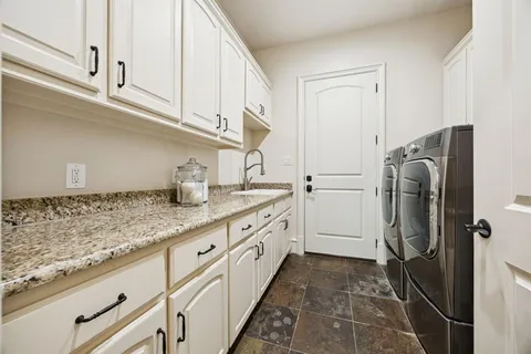 a kitchen with granite countertop cabinets stainless steel appliances a sink and cabinets