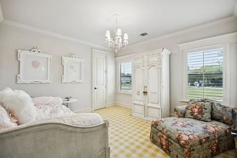 a bedroom with a bed and a chandelier