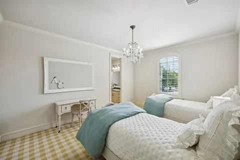 a bedroom with a large bed and a window